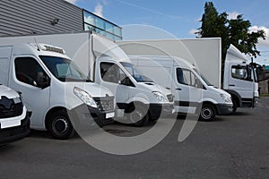 Multiple trucks park in a large parking