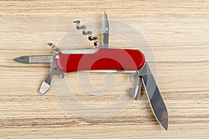 Multipurpose knife on wooden background