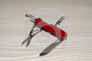 Multipurpose swiss army knife on wooden table