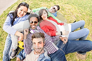 Multiracial best friends taking selfie at meadow picnic - Happy friendship fun concept with young people millenials having fun