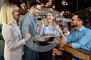 Multiracial business people, friends having fun, working and laughing drinking coffee in coffeehouse