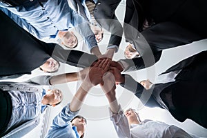 Multiracial business people make synergy hand stack together. Habiliment