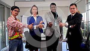 Multiracial business people showing thumbs up together at workplace. Group of confident positive friendly colleague expertise