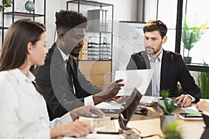 Multiracial business people using modern gadgets on meeting