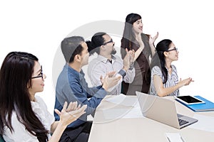 Multiracial business team applauding in office