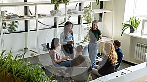 Multiracial businesspeople brainstorm at team briefing in office