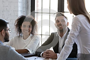 Multiracial businesspeople brainstorm at team meeting together