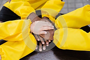 Multiracial children hands together forming pile close-up. Friendship of multinational kids. Childhood.