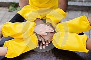 Multiracial children hands together forming pile close-up. Friendship of multinational kids. Childhood.