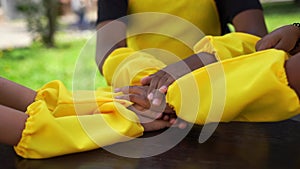 Multiracial children hands together forming pile close-up. Friendship of multinational kids. Childhood.