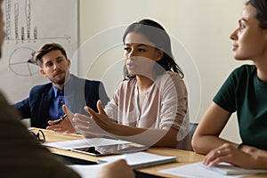 Multiracial colleagues brainstorm discuss ideas at briefing