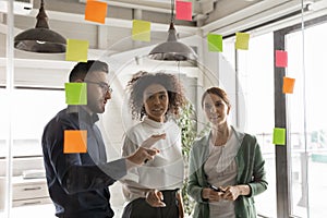 Multiracial colleagues develop ideas in office together