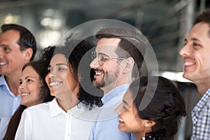Multiracial colleagues smile posing for group picture together