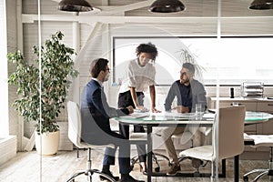Multiracial colleagues talk brainstorm at meeting in office