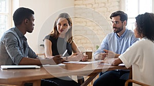 Multiracial colleagues talk brainstorm at office briefing