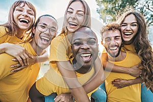 Multiracial community of young people smiling at camera outdoors