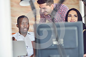 Multiracial contemporary business people working connected with technological devices like tablet and laptop