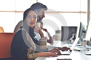 Multiracial contemporary business people working connected with technological devices like tablet and laptop