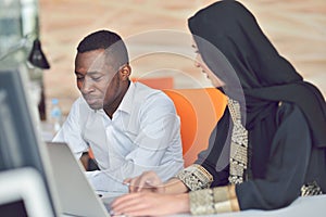 Multiracial contemporary business people working connected with technological devices like tablet and laptop