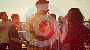 Multiracial couple dancing at roof party. People having fun at open air disco.