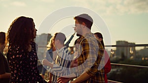 Multiracial couple dancing at roof party. People having fun at open air disco.