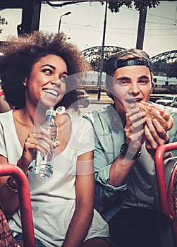 Multiracial couple riding on a sightseeing bus