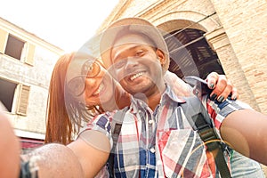 Multiracial couple taking selfie at old town trip travel