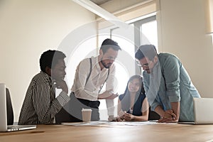 Multiracial employees talk brainstorming at team briefing in office