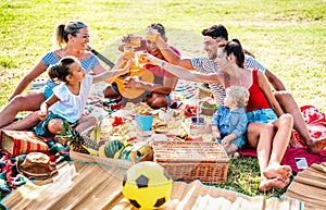 Multiracial families having fun together with kids at pic nic barbecue party - Joy and love life style concept photo