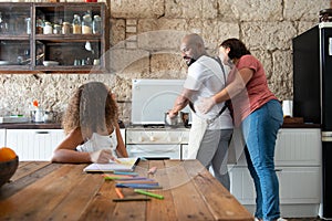 Multiracial family sharing their time in the kitchen of the home