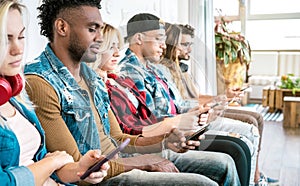 Multiracial friends group on bored moment using smartphone - Addicted people hypnotized by mobile smart phone and social media