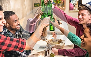 Multiracial friends group drinking and toasting beer at restaurant