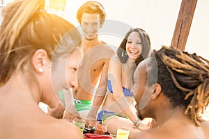 Multiracial friends having genuine fun at beach - Summer concept