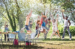 Multiracial friends jumping at barbecue pic nic garden party - Friendship multicultural concept with young happy people having fun