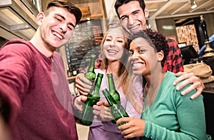 Multiracial friends taking selfie and drinking beer at fancy brewery pub