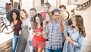 Multiracial friends walking and talking in city center - Happy g