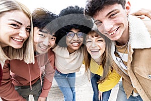 Multiracial group of best friends taking self photo smiling at camera - Happy mixed race teens having fun hanging out