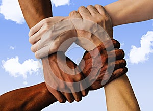 Multiracial group with black african American Caucasian and Asian hands holding each other wrist in tolerance unity love and anti