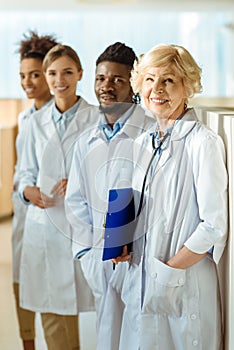 A multiracial group of doctors in lab coats standing in a