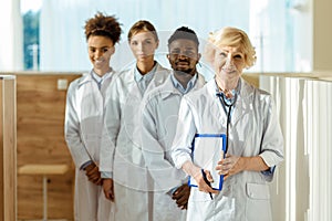 A multiracial group of doctors in lab coats standing