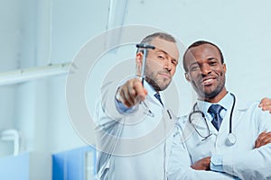 Multiracial group of doctors in medical uniforms in clinic
