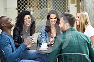 Multiracial group of five friends having a coffee together