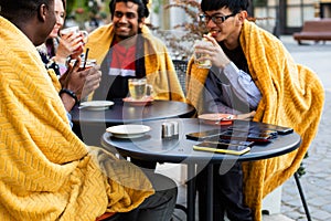 Multiracial group of friends having a drink together