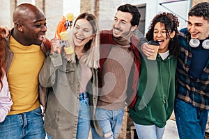 Multiracial group of friends having fun together on city street