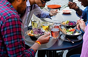 Multiracial group of friends having lunch together