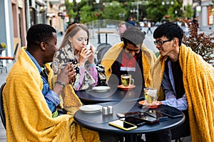 Multiracial group of friends having lunch together