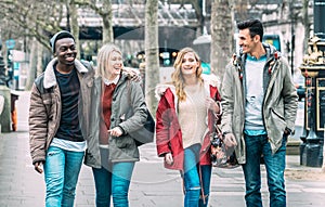 Multiracial group of millenial friends walking at London city center - Next generation friendship concept on multicultural young photo