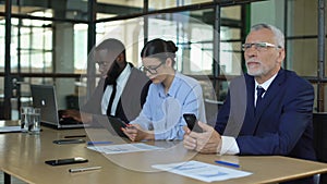 Multiracial group of office employees working smartphone, tablet and laptop