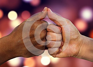 Multiracial hands together African American and Caucasian touching thumbs as team in promise sign of mutual trust representing