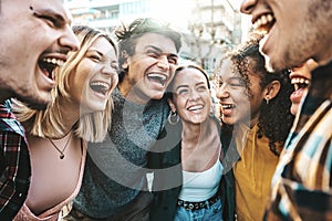 Multiracial happy best friends laughing walking outside